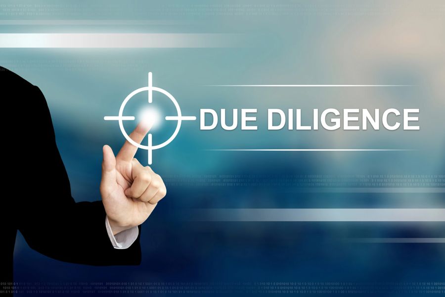 A hand selecting a due diligence control on a digital interface.